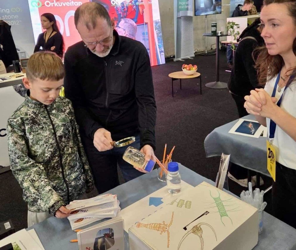 Ungur drengur og aðstandandi velta fyrir sér fjölda rauðáta í krukku á Vísindavöku Rannís en ekki vi…